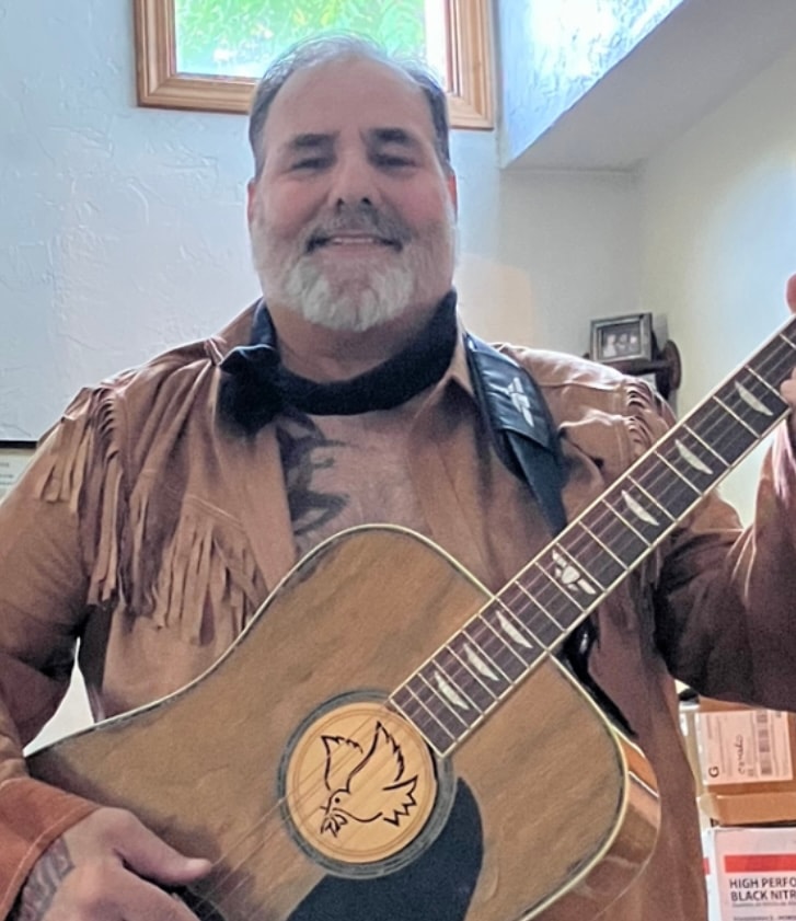 Johnny Evil Racing guitarist with acoustic guitar
